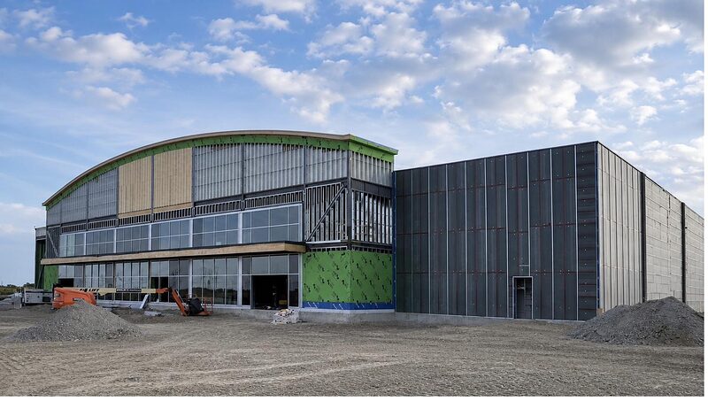Commercial building exterior with sheathing and cladding in progress