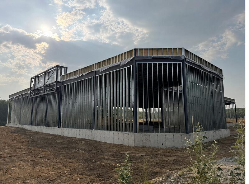 Steel-framed commercial building at dusk