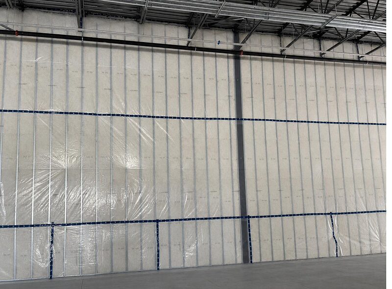 Insulated wall assembly with vapour barrier in a commercial interior