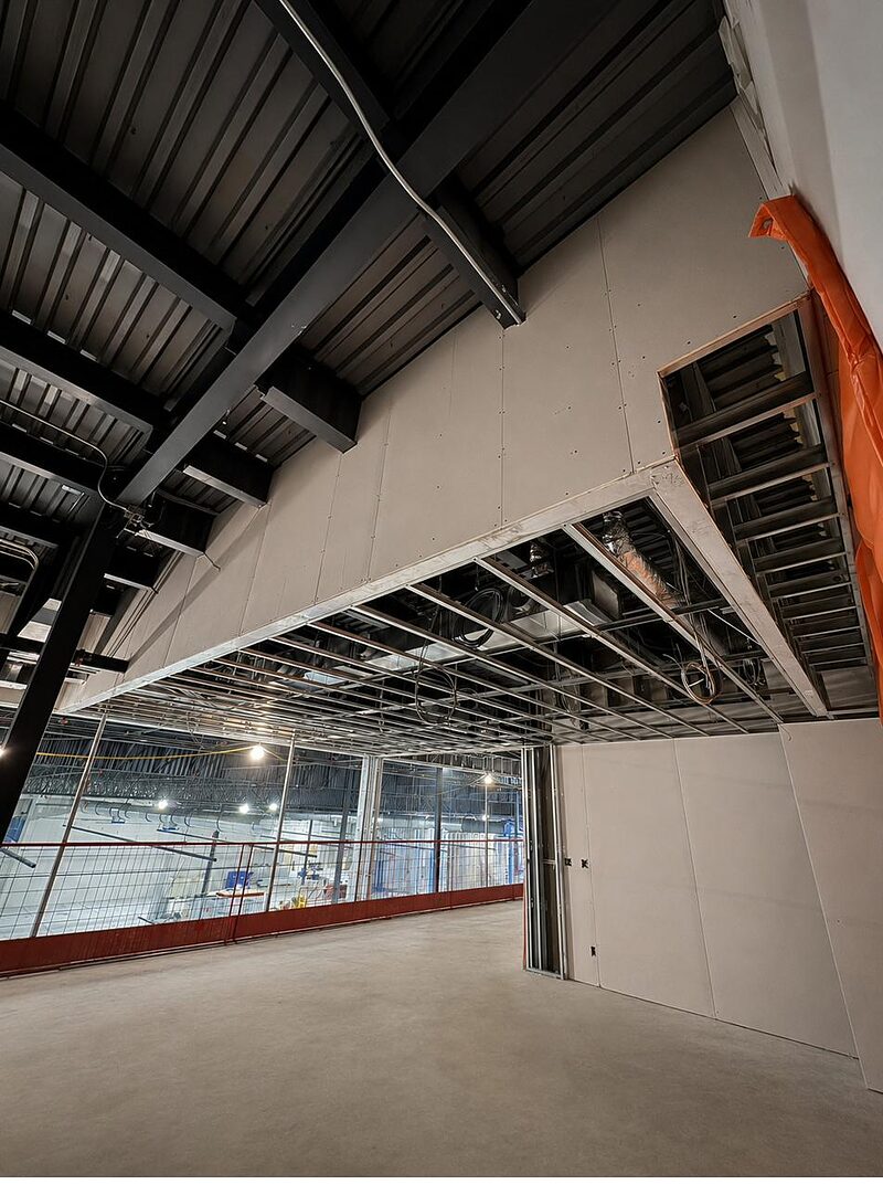 Drywall bulkhead and soffit framing at the underside of a steel roof deck