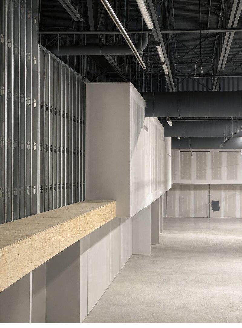 Interior steel-stud framing with drywall bulkhead above